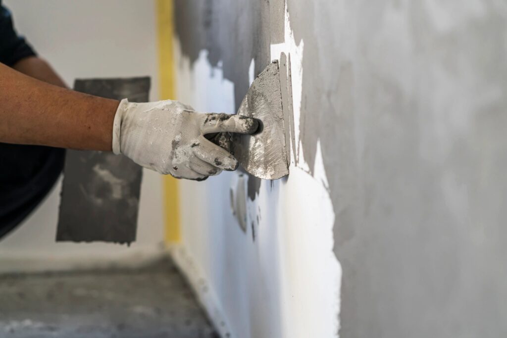 Close up of human hands working on concrete wall texture